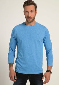 Langarmshirt in heatherblau stof. Ontwerp met ronde hals en een gestructureerd oppervlak. Beschikt over een getailleerde pasvorm en een subtiele logodetail.