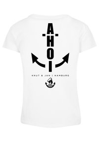 White t-shirt featuring black text "AHOI" and arrows, with "Knut & Jan | Hamburg" below, and an anchor design with a sailor graphic.