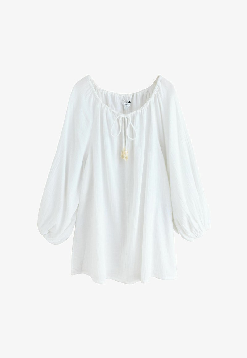 Biela blúzka s dlhými rukávmi, elastickým výstrihom na krku, šnúrkou na zaväzovanie s korálikmi a voľnými nahustenými rukávmi.