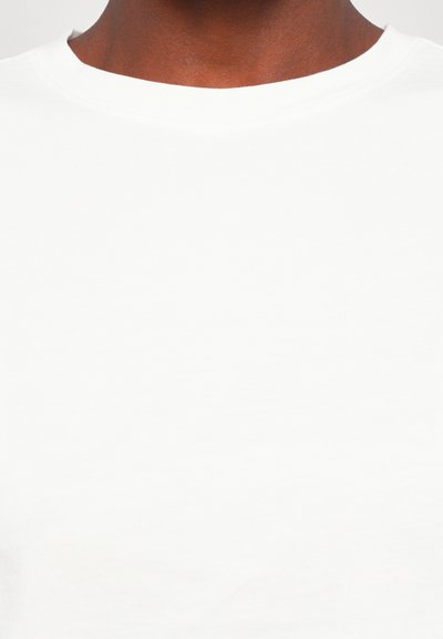 White cotton t-shirt featuring a crew neck design, smooth texture, and no visible patterns or accents.