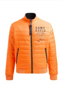Gepolsterte orange Jacke mit Stehkragen, gestepptem Design, schwarzem Reißverschluss-Detail und besticktem Logo auf der Vorderseite. Zwei Reißverschlusstaschen.