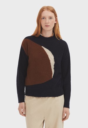 Navy sweater with a geometric design featuring brown and cream sections. Soft texture, round neckline, and long sleeves.
