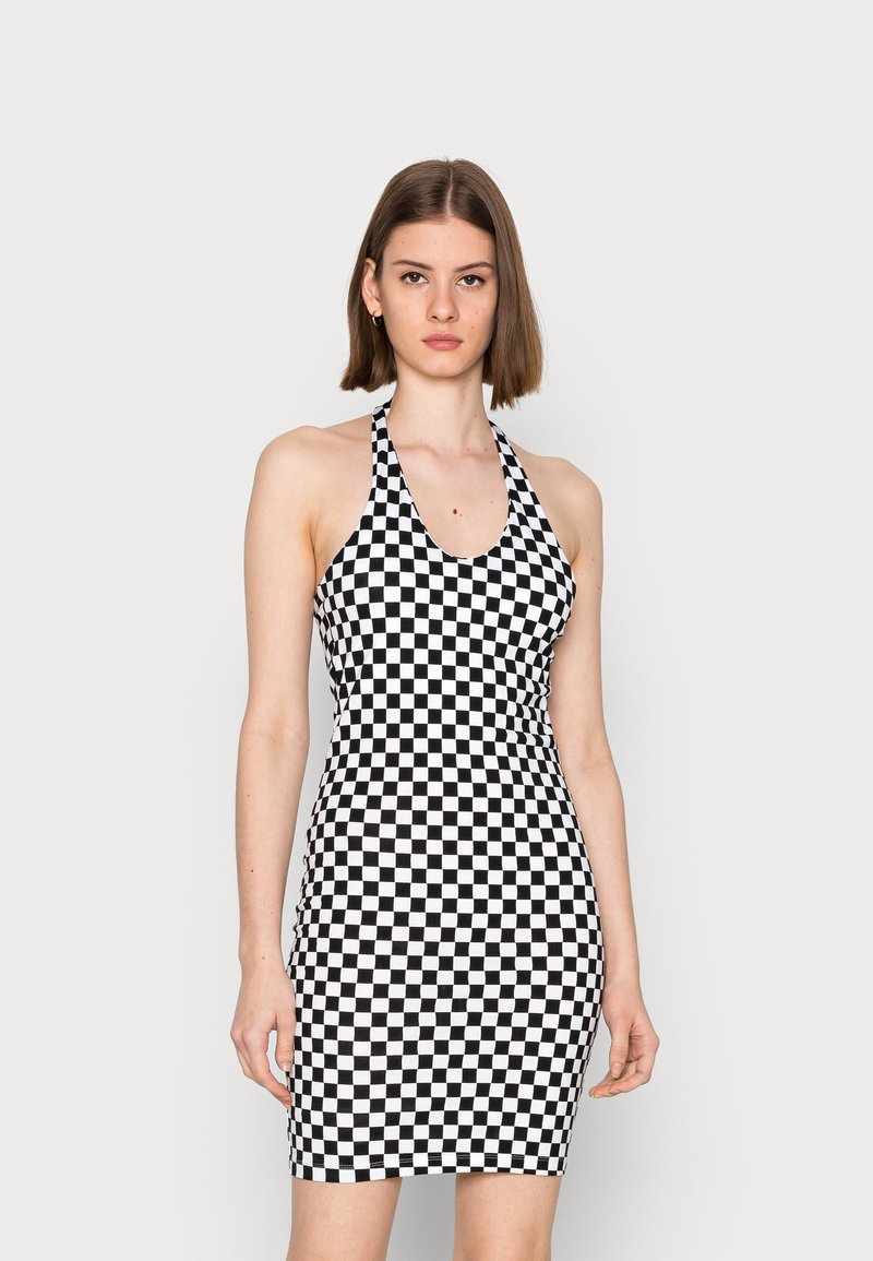 Vestido em padrão de quadrados pretos e brancos, design com pescoço halter, silhueta ajustada, material elástico, textura suave, comprimento até ao joelho.