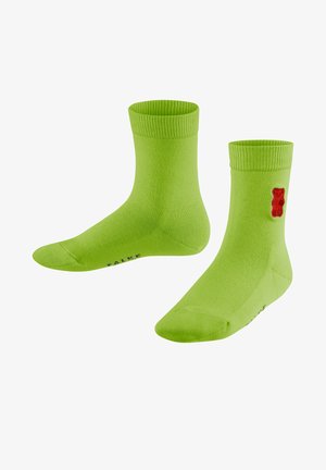 Grüne Baumwollsocken mit einem gerippten Bund, der ein rotes Gummibärchen-Motiv zeigt. Die Socken haben eine glatte Textur und eine Standard-Crew-Länge.