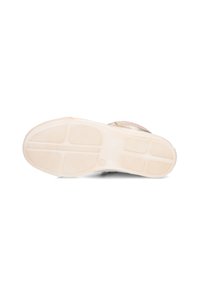 Shoe sole with a textured pattern, made of rubber. Color is off-white with a slight sheen and small logo. Flat design with traction grooves.