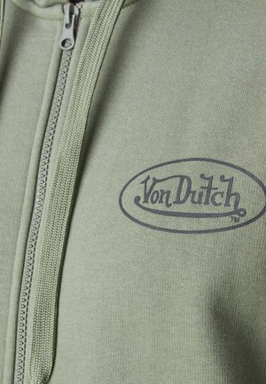 Hoodie zippé vert en tissu texturé avec un logo "Von Dutch" sombre sur le devant.