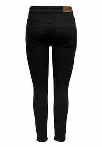 Jeans skinny negros de denim, con una cintura alta, dos bolsillos traseros y un parche de cuero marrón con la marca en la cinturilla.