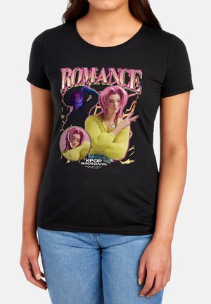 Woman wearing black t-shirt featuring animated character with pink hair, green shirt, and text reading Romance Kpop Demon Hunters.