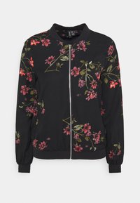 Veste bomber noire avec broderie florale en rose et vert, dotée d'une fermeture éclair à l'avant et de poignets et ourlet côtelés. Tissu léger.