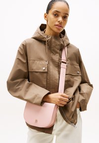 Tommy Hilfiger LOGOTAPE SADDLE BAG - Cross body bag - pink