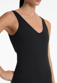 Black swimsuit with a V-neckline, slim shoulder straps, and cut-out side detail. The fabric appears smooth and stretchy with a matte finish.