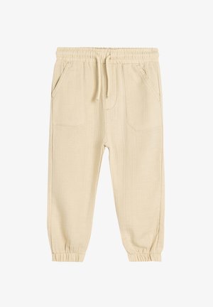 Beige, elastiske bukser med taljebånd, der har to sidelommer, tapered cuffs og en struktureret stofoverflade.