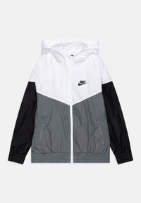 Hooded Nike windbreaker with white upper, gray midsection, black sleeves, front zipper, and zippered side pockets, laid flat on white background.