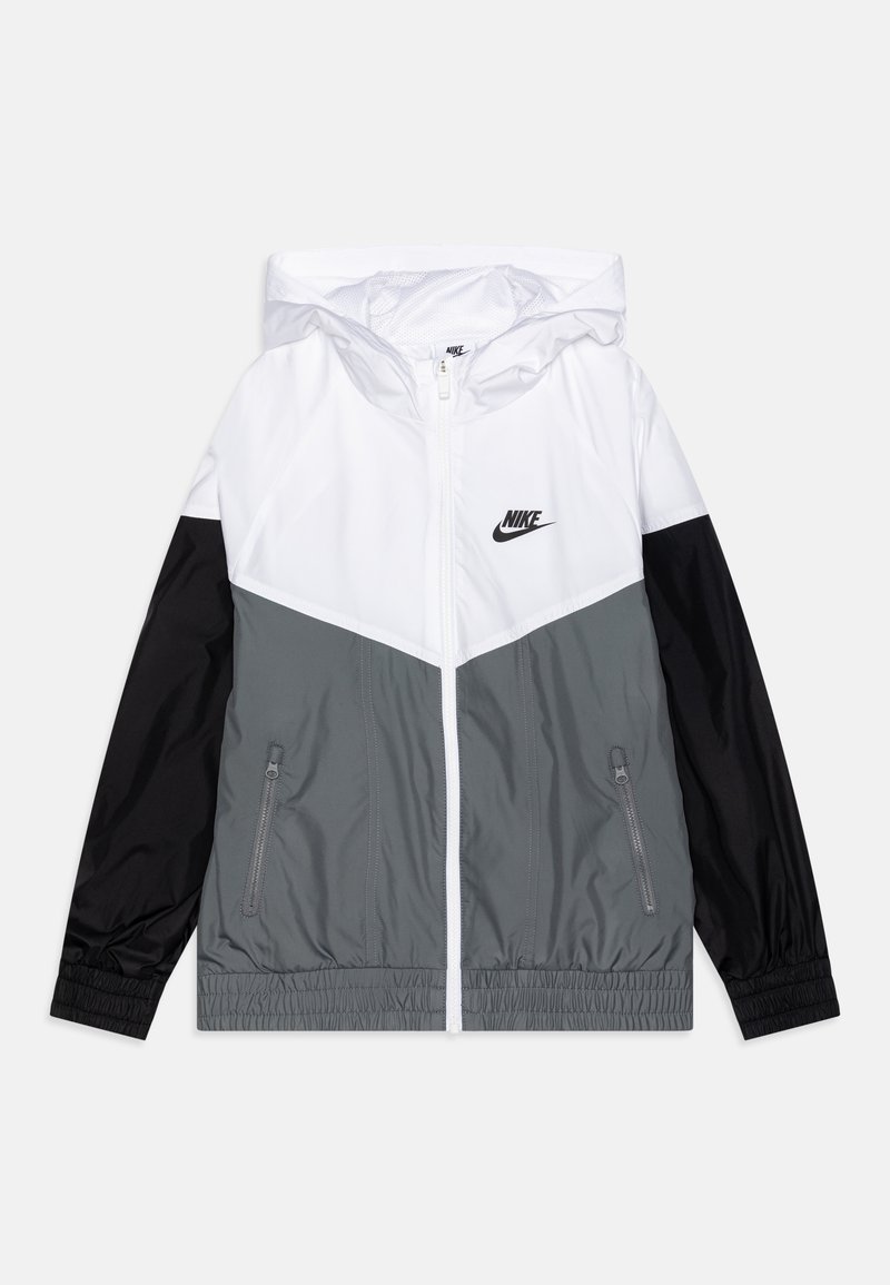 Hooded Nike windbreaker with white upper, gray midsection, black sleeves, front zipper, and zippered side pockets, laid flat on white background.