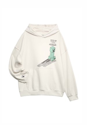 Off-white hættetrøje med frontlomme med Minecraft Creeper-grafik og teksten "Survival Mode Adventure Is An Attitude" på brystet og ærmet.