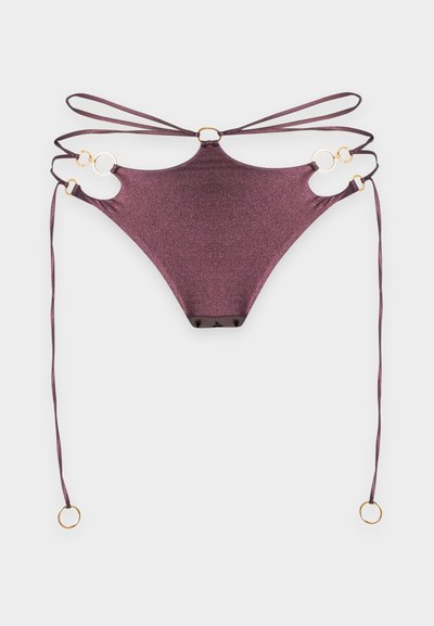 Bas de bikini métallisé violet avec plusieurs fines bretelles et accents d'anneaux dorés sur fond blanc.