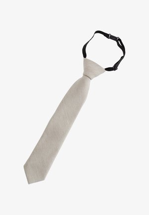 Cravate beige pré-nouée avec sangle réglable noire et boucle pour un port facile.