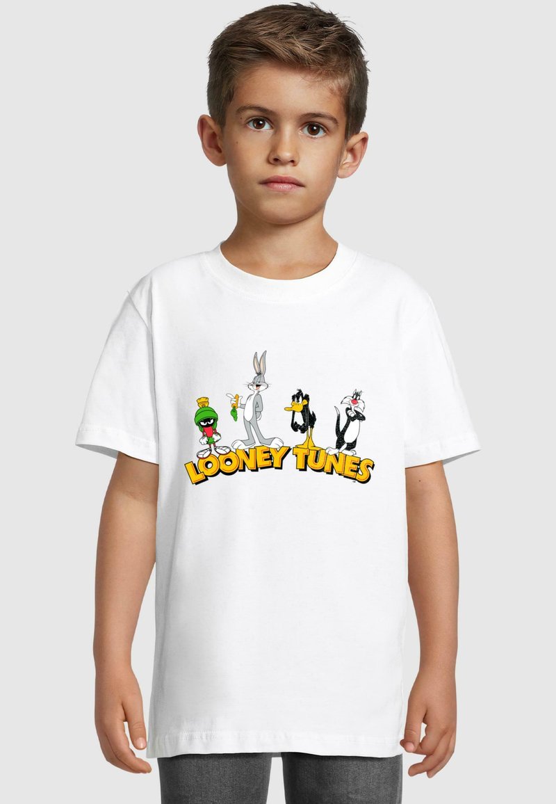 White cotton T-shirt featuring Looney Tunes characters: Bugs Bunny, Daffy Duck, Sylvester, and Marvin the Martian. Bold yellow text below them.