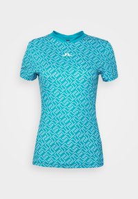 Turquoise kortekapot met een geometrisch wit patroon. Kenmerken zijn een ronde hals en een gladde, lichte stof.