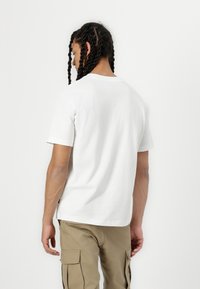 New Balance NEWBIE CHASE UNISEX - T-shirts print - white