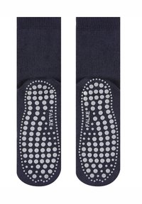 Sötétkék zokni texturált gumírozott tapadási mintákkal, különböző méretű pöttyökkel a talpakon. Mindkét zoknin FALKE logó található. Simafonalas felsőrész.