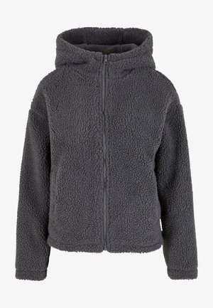 Siva flis zadrga s kapuco in dolgimi rokavi z teksturirano površino. Ima osrednjo zadrgo in elastične manšete.