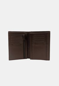 Portefeuille en cuir marron ouvert pour montrer plusieurs emplacements pour cartes et une poche zippée pour les pièces ou les objets, avec une texture lisse et un design simple.