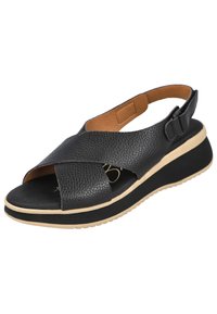 Sandaal de cuero negro con diseño de tiras cruzadas, punta abierta, plantilla acolchada y suela de plataforma gruesa con un acabado texturizado en negro y beige.