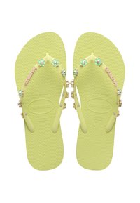Yellow rubber flip-flops with textured soles, decorated with small mint-green flowers and metal accents on the straps. Size 37-38.