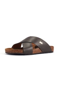 Dark brown slide sandal with crossed synthetic straps, cork footbed, and textured rubber sole. Notable stitching accent and logo detail.