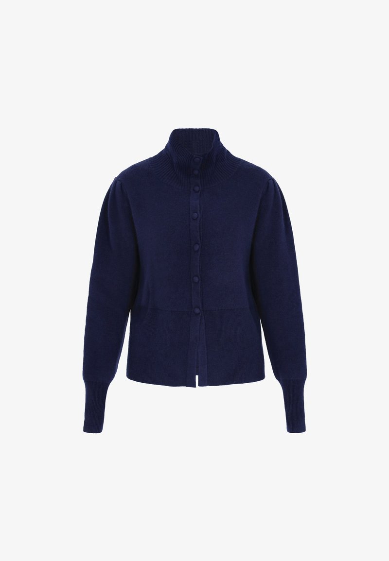 Cárdigan de punto en color navy con un alto cuello acanalado, seis botones frontales y puños acanalados. Presenta mangas abullonadas y un diseño corto.