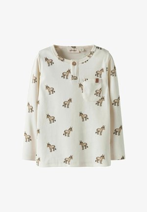 Långärmad, krämfärgad skjorta med knäppning vid halsen; har ett upprepat åsneprint och en liten ficka, tillverkad av mjukt tyg.