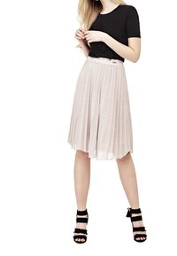 Top negro de manga corta combinado con una falda plisada rosa clara. La falda tiene una cintura ajustada y una tela suave y texturizada. Tacones negros con tiras.