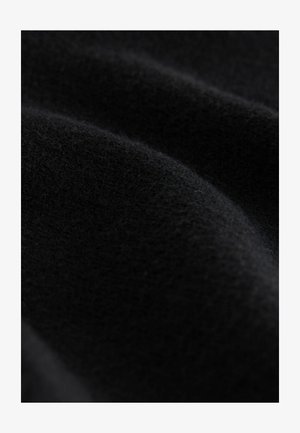 Black wool fabric with a soft, smooth texture; features gentle folds and a consistent, deep color. No visible patterns or hardware.