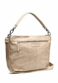 Sac à épaule en cuir beige avec une texture lisse, doté d'une poche zippée à l'avant, d'une sangle réglable et d'une étiquette de marque discrète.
