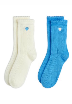 Cotton socks in creamy white and blue, featuring ribbed texture and a small heart design near the top in contrasting blue and white.