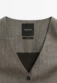 Gray linen blazer with black button, black interior lining, and "Massimo Dutti" brand label sewn inside collar.