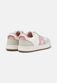 White and light pink sneakers with a suede grey heel. Features a pink side logo and textured panels. Rubber sole with stitching detail.