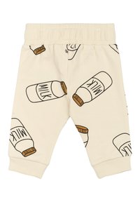 Helle beige Kinderhose mit elastischem Bund, versehen mit einem wiederholten Grafikdesign von Milchflaschen in braunen und schwarzen Linien. Weiches Baumwollmaterial.