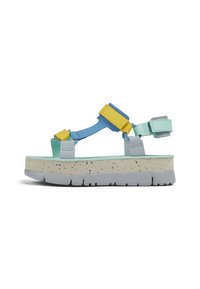 Sandali con piattaforma caratterizzati da una combinazione di cinturini blu, gialli e menta, con una suola beige maculata e una base in gomma grigia. Inclusi cinturini regolabili.