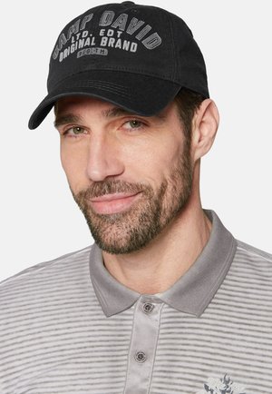 Black cap with "CAMP DAVID" text, cotton material, curved brim. Gray striped polo shirt with a button-down collar and embroidered detail.