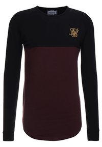 Långärmad t-shirt med rund halsringning med svart överdel och ärmar, mörkröd nedre del och guld broderad logotyp på vänster bröst.