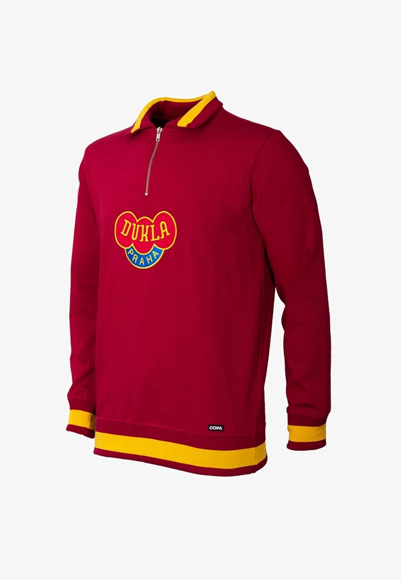 Bordeaux lange mouw pullover met een gele kraag en manchetten. Voorzien van een ritssluiting bij de hals en een levendig logo "DUKLA PRAHA" in het midden.