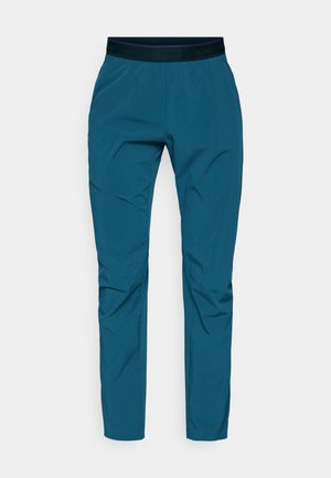 Tyrkysové outdoorové kalhoty z lehkého materiálu. Mají černý elastický pas a vytvarovaný střih s mírným zúžením u kotníků.