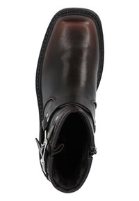 Botín de cuero con un acabado pulido en marrón oscuro, con punta redondeada, acentos de metal plata y un forro interior suave.