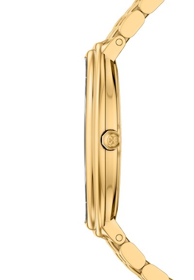 Vue latérale d'une montre-bracelet fine en or avec un bracelet en métal poli et une couronne texturée sur le côté droit.