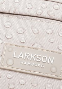 Tessuto grigio chiaro con una finitura testurizzata, caratterizzato da gocce d'acqua in rilievo e un'etichetta beige con la scritta "LARKSON HAMBURG."
