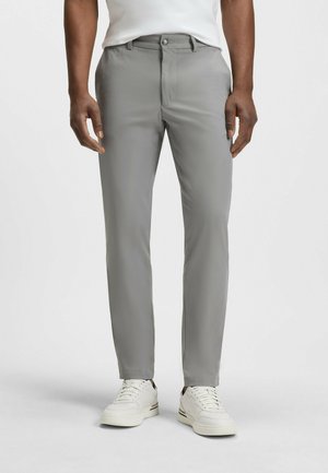 Gray dress pants made from smooth material, featuring a classic fit, front pockets, and paired with white sneakers for a casual look.