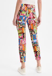 Kleurige, cartoon-patronen broek met verschillende geïllustreerde gezichten en spraakbubbels. Gemaakt van stof met een slim-fit ontwerp en enkel lengte.