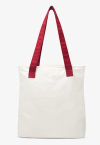 Υφασμάτινη τσάντα ώμου σε εκρού χρώμα με διπλούς κόκκινους ιμάντες από ύφασμα. Διαθέτει απλό ορθογώνιο σχήμα, ανθεκτικό υλικό και καθαρές γραμμές.
